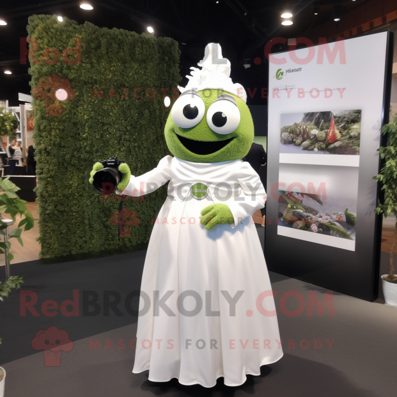 Olive Camera mascot costume character dressed with a Wedding Dress and Keychains