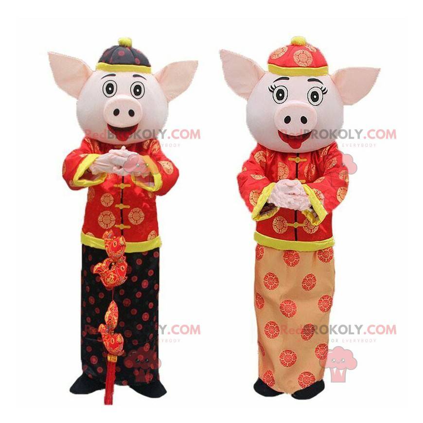 2 asiatiska grisar, kinesisk skyltmaskot, kinesiskt nyår -