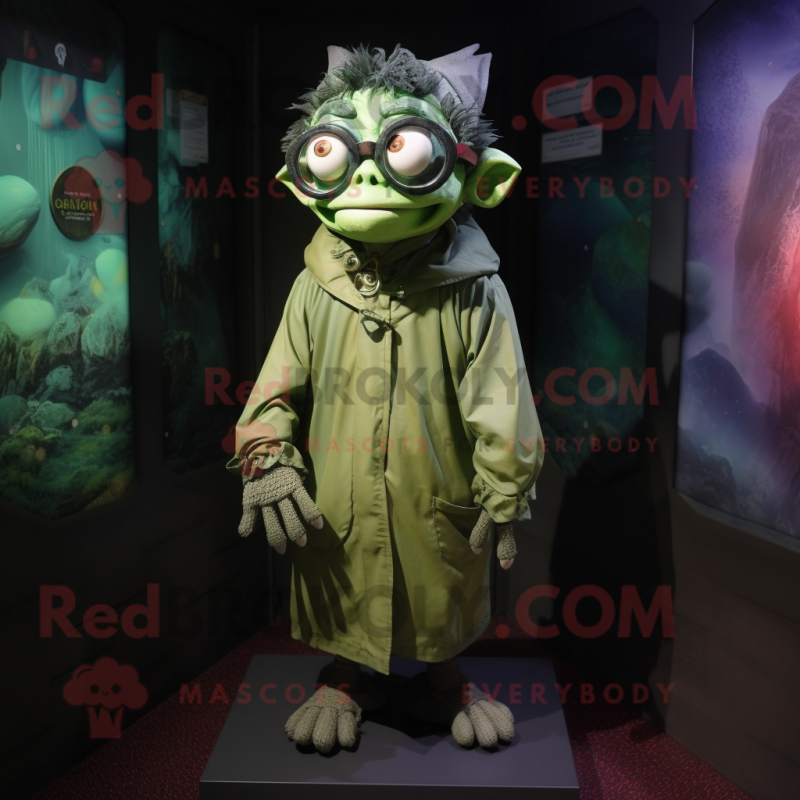 Olive Gargoyle mascot costume character dressed with a Raincoat and Eyeglasses Olive Gargoyle mascot costume character dressed with a Raincoat and Eyeglasses