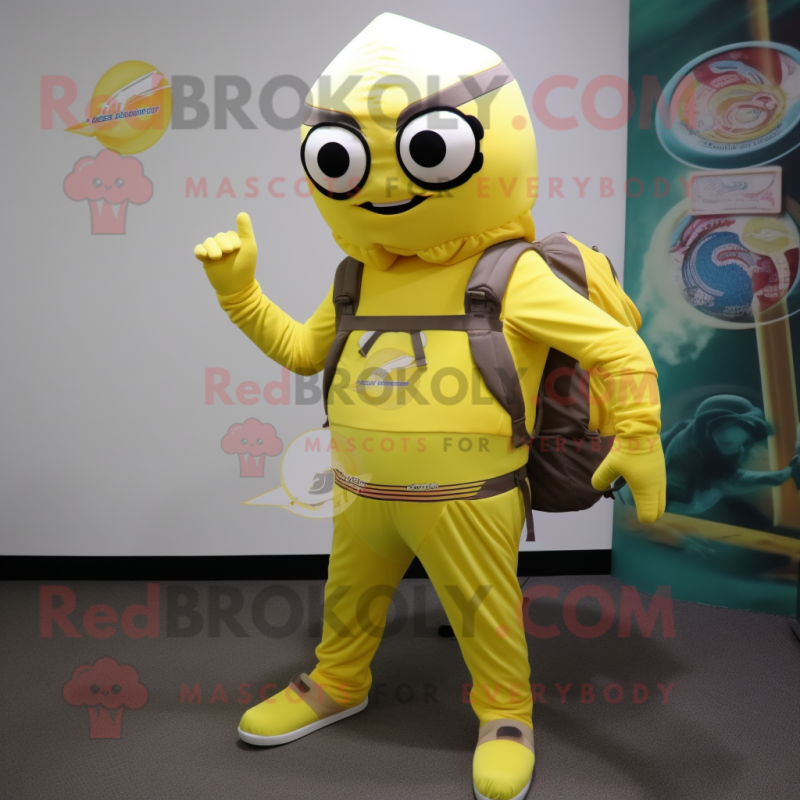 Lemon Yellow Commando mascot costume character dressed with a Long Sleeve Tee and Messenger bags Lemon Yellow Commando mascot costume character dressed with a Long Sleeve Tee and Messenger bags