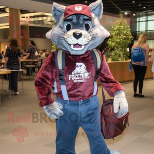 Maroon Bobcat mascot costume character dressed with a Chambray Shirt and Messenger bags