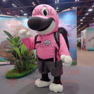 Pink Killer Whale mascot costume character dressed with a Cargo Shorts and Backpacks