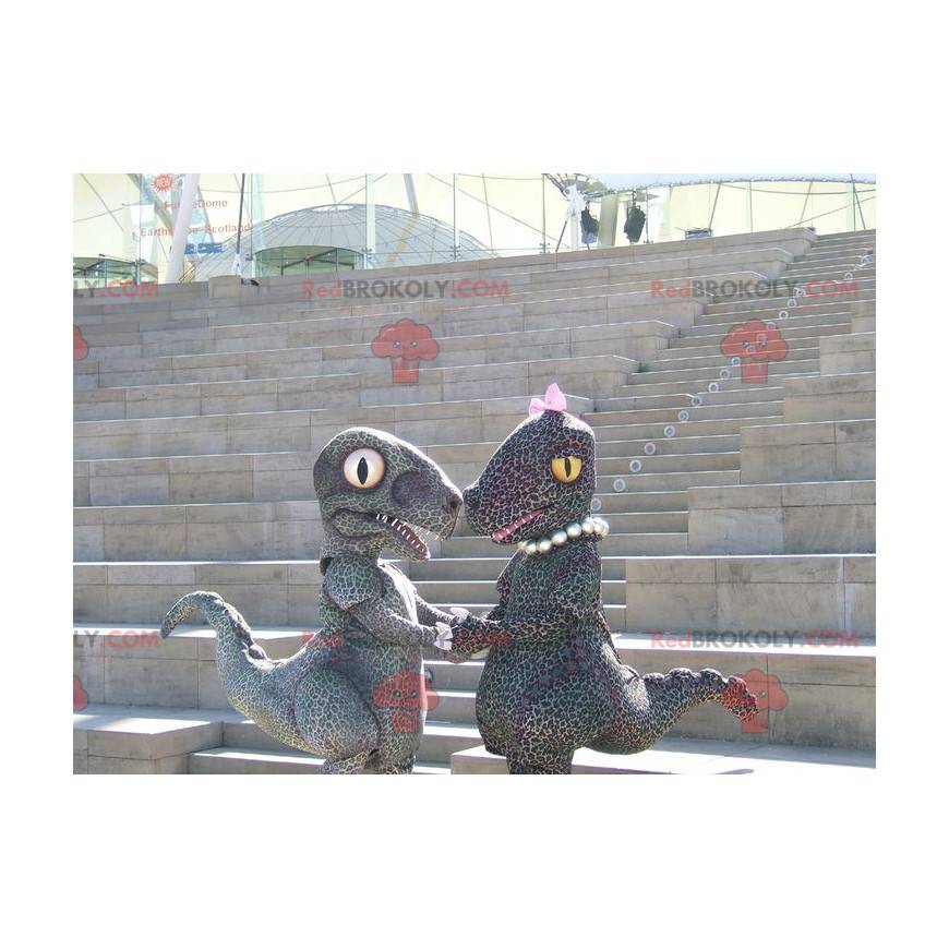 2 mascottes de dinosaures de couple tacheté façon guépard -