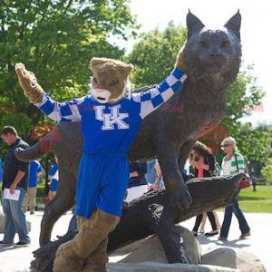 Brown and white tiger mascot in blue outfit - Redbrokoly.com