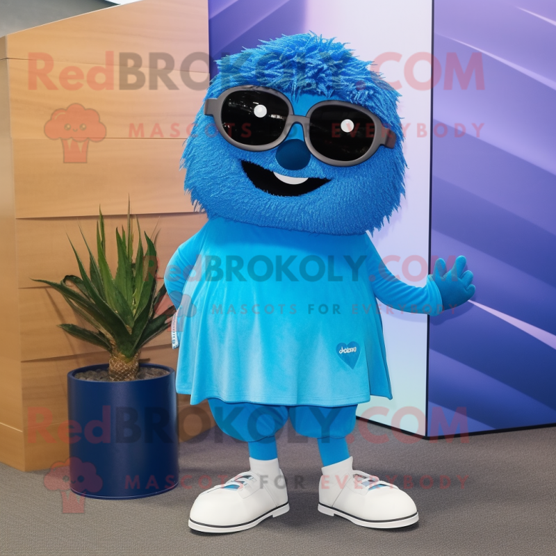 Blue Aglet mascot costume character dressed with a A-Line Skirt and Sunglasses Blue Aglet mascot costume character dressed with a A-Line Skirt and Sunglasses