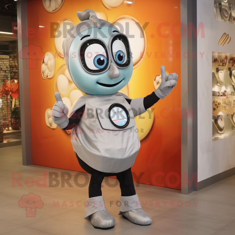 Silver Shakshuka mascot costume character dressed with a Shift Dress and Smartwatches Silver Shakshuka mascot costume character dressed with a Shift Dress and Smartwatches