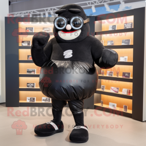 Black Boxing Glove mascot costume character dressed with a Board Shorts and Reading glasses