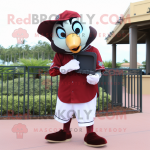 Maroon Toucan mascot costume character dressed with a Baseball Tee and Clutch bags