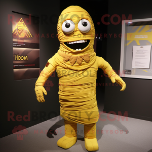 Yellow Mummy mascot costume character dressed with a Romper and Tie pins