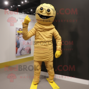 Yellow Mummy mascot costume character dressed with a Romper and Tie pins