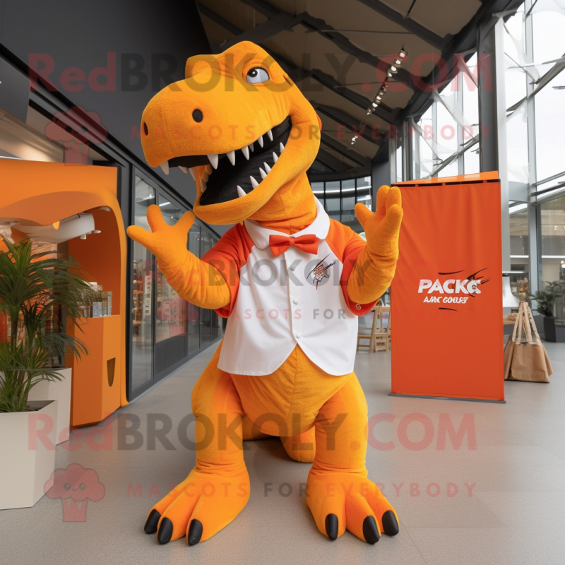 Orange T Rex mascot costume character dressed with a Trousers and Tote bags Orange T Rex mascot costume character dressed with a Trousers and Tote bags