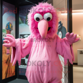 Pink Vulture mascot costume character dressed with a Jumpsuit and Mittens