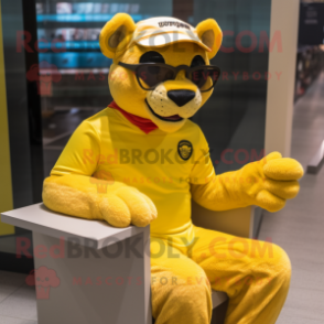 Yellow Puma mascot costume character dressed with a Rash Guard and Reading glasses