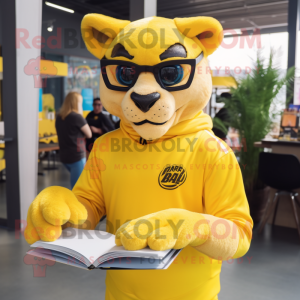 Yellow Puma mascot costume character dressed with a Rash Guard and Reading glasses