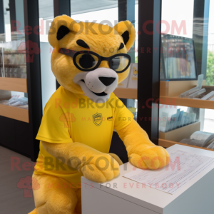 Yellow Puma mascot costume character dressed with a Rash Guard and Reading glasses