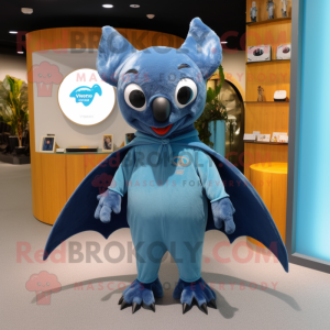 Blue Fruit Bat mascot costume character dressed with a Jumpsuit and Mittens