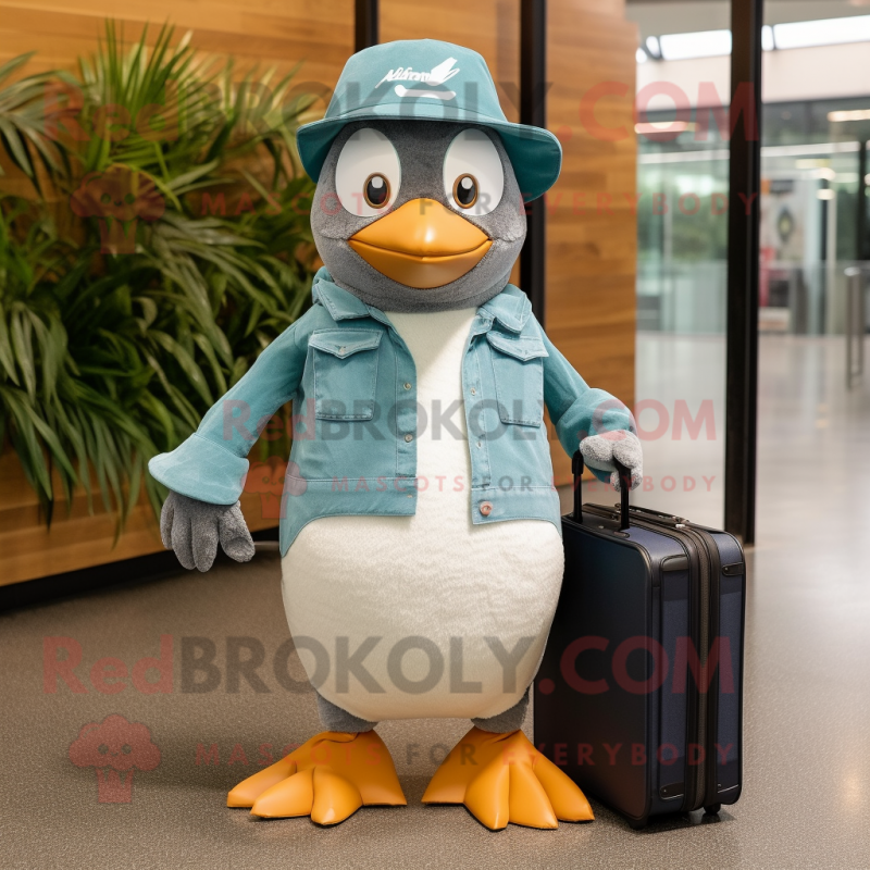Teal Penguin mascot costume character dressed with a Chambray Shirt and Briefcases
