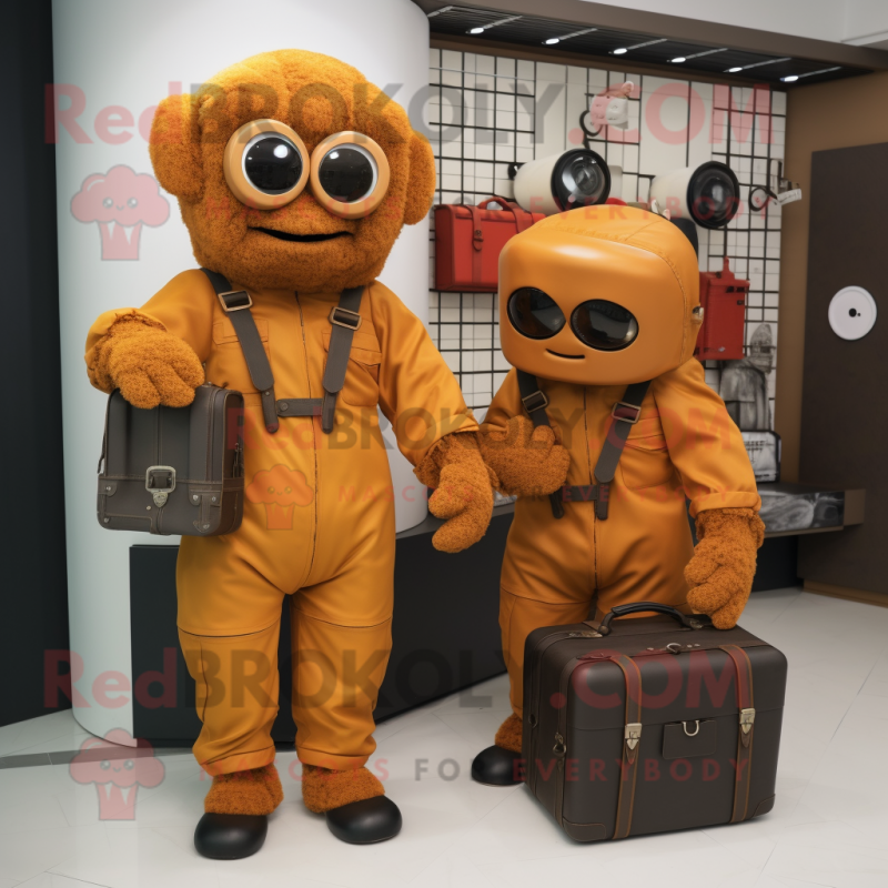 Rust Television mascot costume character dressed with a Jumpsuit and Handbags Rust Television mascot costume character dressed with a Jumpsuit and Handbags
