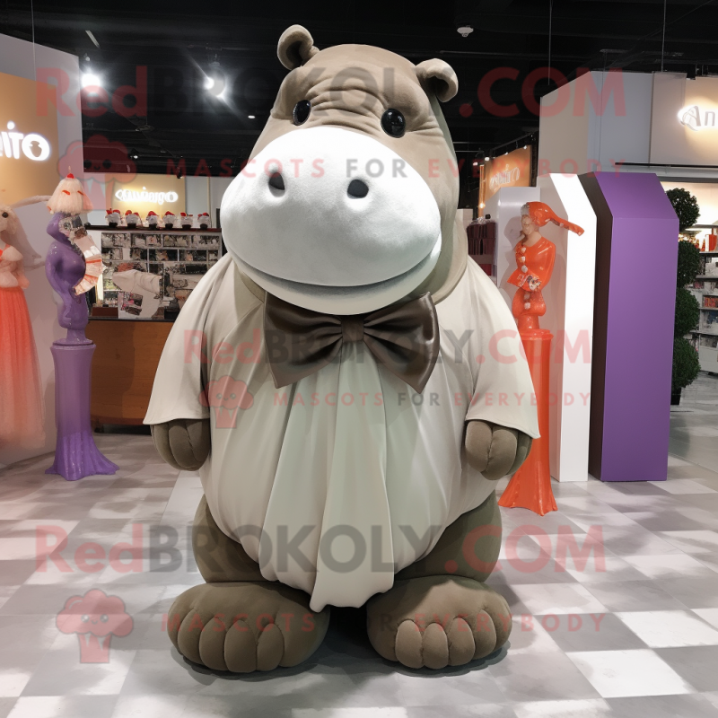 Tan Hippopotamus mascot costume character dressed with a Pleated Skirt and Bow ties