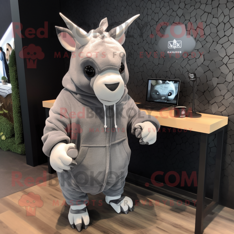 Gray Rhinoceros mascot costume character dressed with a Hoodie and Earrings