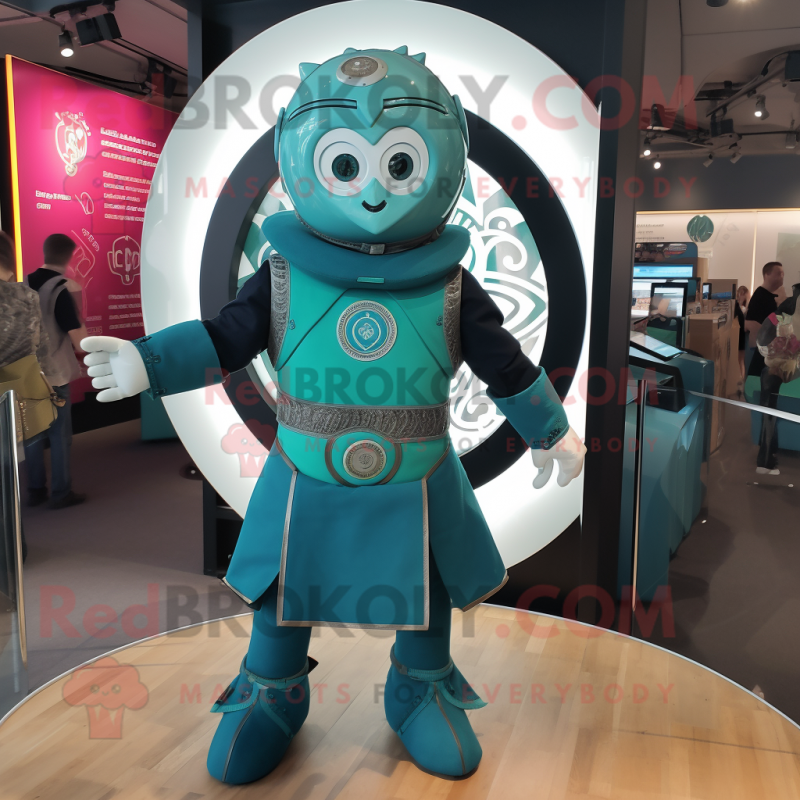 Teal Celtic Shield mascot costume character dressed with a Playsuit and Suspenders Teal Celtic Shield mascot costume character dressed with a Playsuit and Suspenders