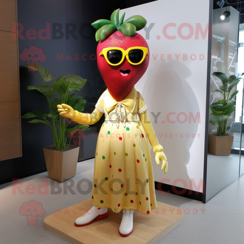 Gold Strawberry mascot costume character dressed with a Maxi Dress and Eyeglasses Gold Strawberry mascot costume character dressed with a Maxi Dress and Eyeglasses