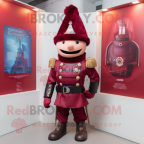 Maroon British Royal Guard mascot costume character dressed with a Moto Jacket and Keychains