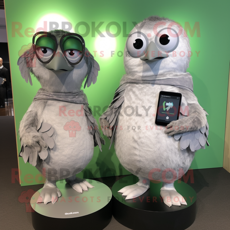 Silver Kiwi mascot costume character dressed with a Wrap Dress and Smartwatches Silver Kiwi mascot costume character dressed with a Wrap Dress and Smartwatches