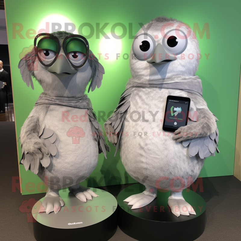 Silver Kiwi mascot costume character dressed with a Wrap Dress and Smartwatches