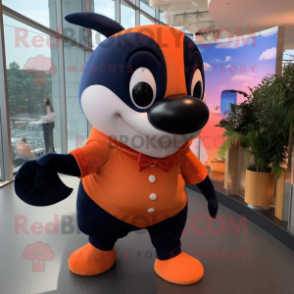 Orange Killer Whale mascot costume character dressed with a Shift Dress and Ties