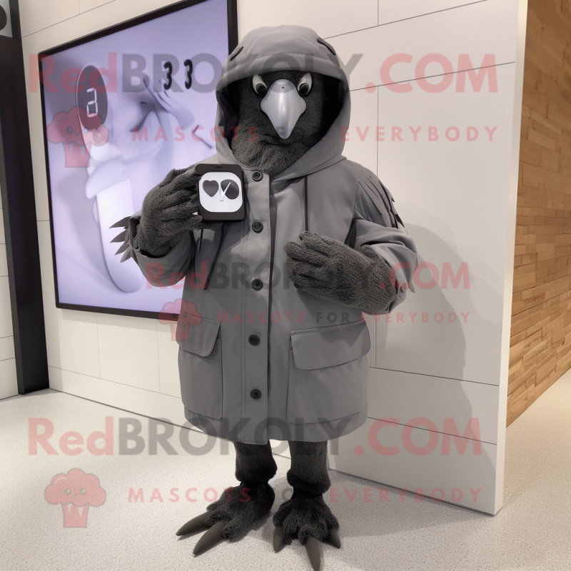 Gray Blackbird mascot costume character dressed with a Parka and Smartwatches Gray Blackbird mascot costume character dressed with a Parka and Smartwatches