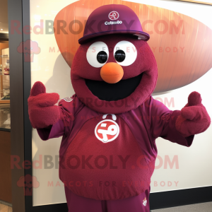 Maroon Plum mascot costume character dressed with a Graphic Tee and Brooches