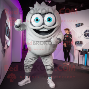 Silver Cyclops mascot costume character dressed with a Joggers and Smartwatches