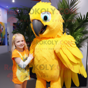 Yellow Macaw mascot costume character dressed with a Playsuit and Hair clips