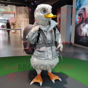 Silver Muscovy Duck mascot costume character dressed with a Wrap Dress and Backpacks