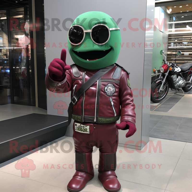 Maroon Green Bean mascot costume character dressed with a Biker Jacket and Rings