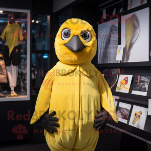 Yellow Blackbird mascot costume character dressed with a Playsuit and Mittens