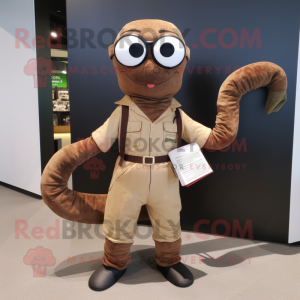 Brown Snake mascot costume character dressed with a Dungarees and Reading glasses