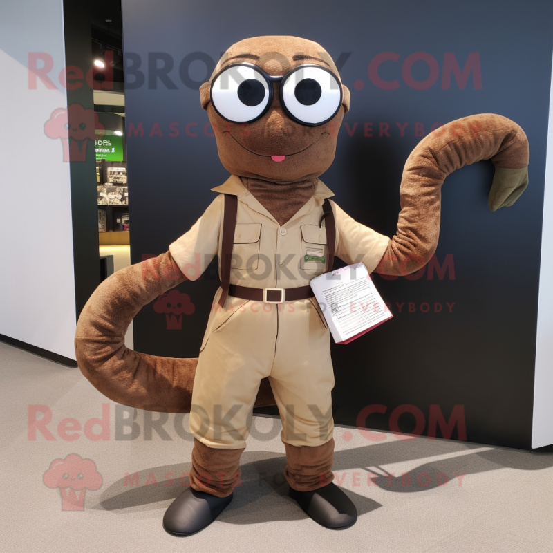 Brown Snake mascot costume character dressed with a Dungarees and Reading glasses Brown Snake mascot costume character dressed with a Dungarees and Reading glasses