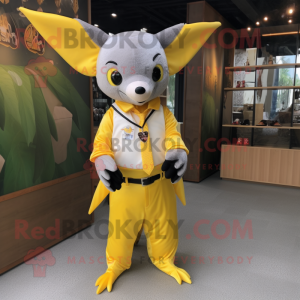 Yellow Fruit Bat mascot costume character dressed with a Suit Pants and Keychains