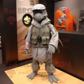 Gray Para Commando mascot costume character dressed with a Graphic Tee and Shawl pins