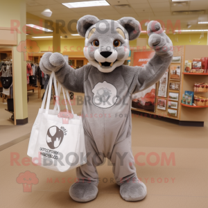 Gray Mountain Lion mascot costume character dressed with a Long Sleeve Tee and Tote bags