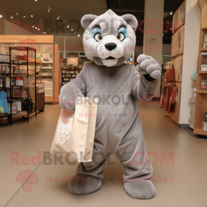 Gray Mountain Lion mascot costume character dressed with a Long Sleeve Tee and Tote bags