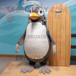 Gray Penguin mascot costume character dressed with a Board Shorts and Caps
