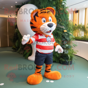 Orange Tiger mascot costume character dressed with a Rugby Shirt and Hat pins
