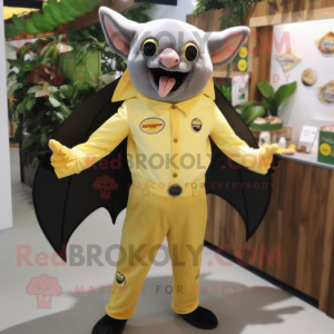 Lemon Yellow Fruit Bat mascot costume character dressed with a Trousers and Suspenders