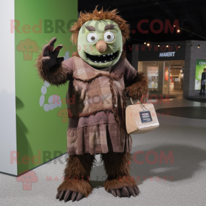 Brown Frankenstein'S Monster mascot costume character dressed with a Cardigan and Coin purses