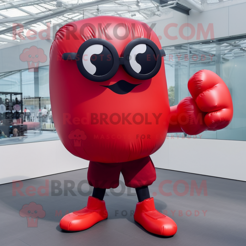 Red Boxing Glove mascot costume character dressed with a Skirt and Sunglasses Red Boxing Glove mascot costume character dressed with a Skirt and Sunglasses