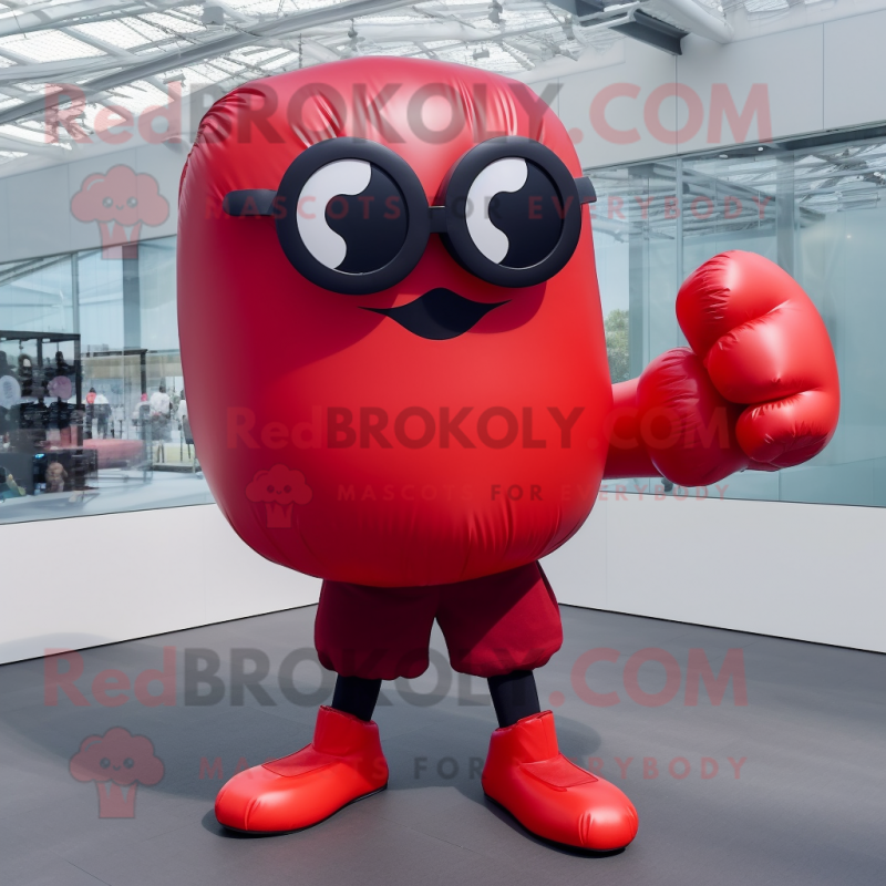 Red Boxing Glove mascot costume character dressed with a Skirt and Sunglasses