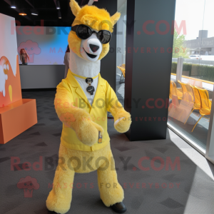 Yellow Llama mascot costume character dressed with a Dress Pants and Sunglasses